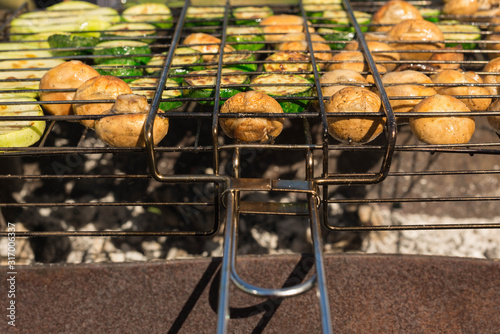 Shish kebab of mushrooms on the grill in the grill. Summer. Meal. Vegetarianism.