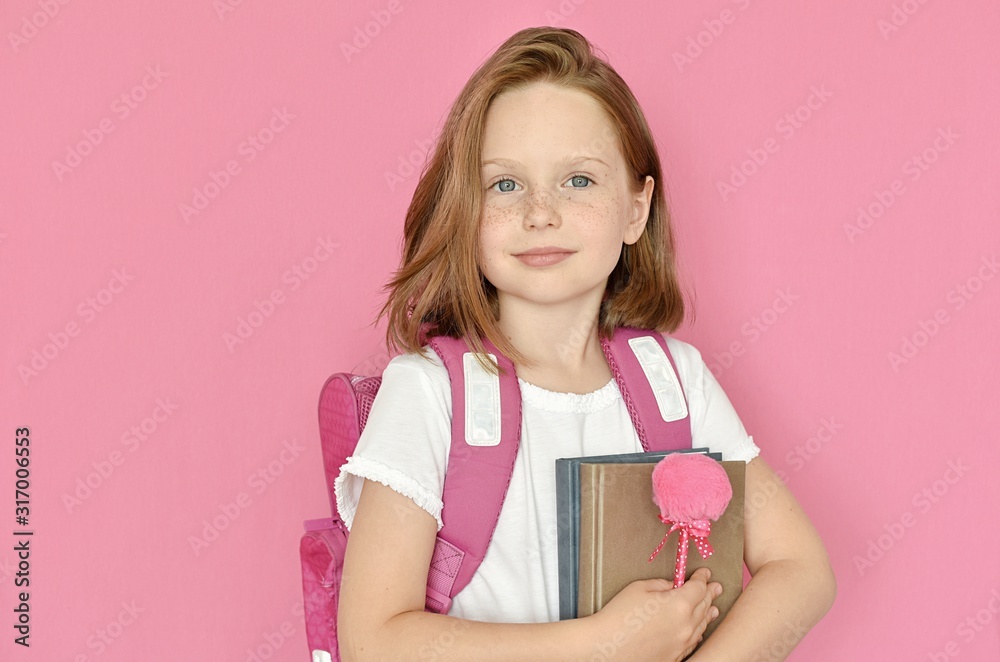 Studio portrait of happy teenage school girl with backpack, books and pink fluffy pencil, back to school, education concept. Studio portrait of happy teenage school girl with backpack, books and pink fluffy pencil, back to school, education concept.