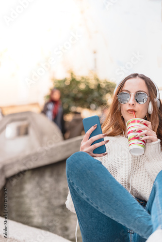 beautiful young girl uses smart phone while sitting © epic_images