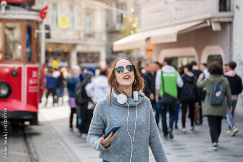 Beautifu girl walks at popular Istiklal street in Istanbul,Turkey