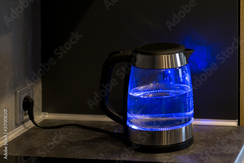  Electric kettle boils in the kitchen