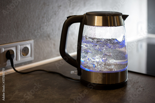  Electric kettle boils in the kitchen