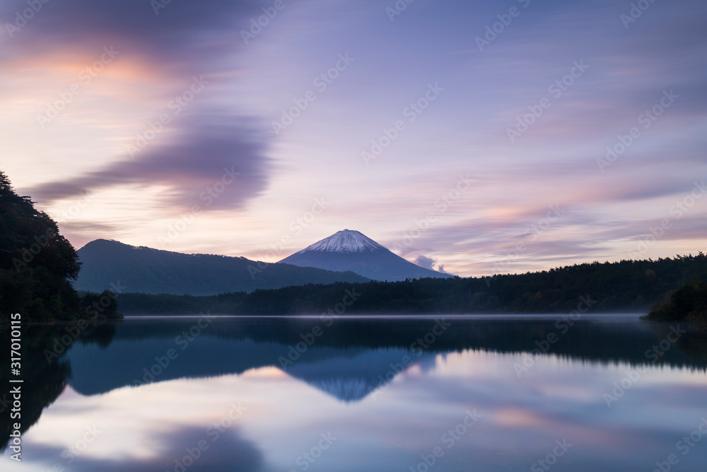 View of Mount Fuji at sunrise on a peaceful morning from lake Saiko, Yamanashi Prefecture, Japan