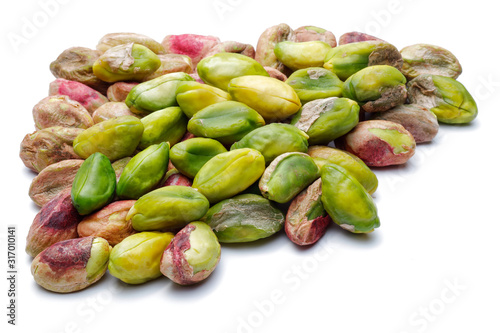 Heap of peeled pistachio nuts isolated