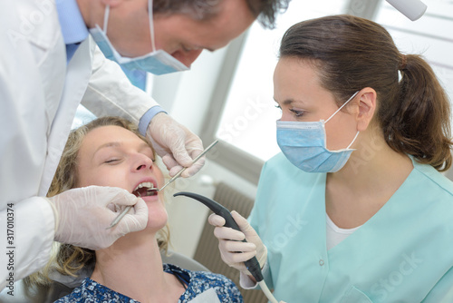 dentists examining a patient teeth