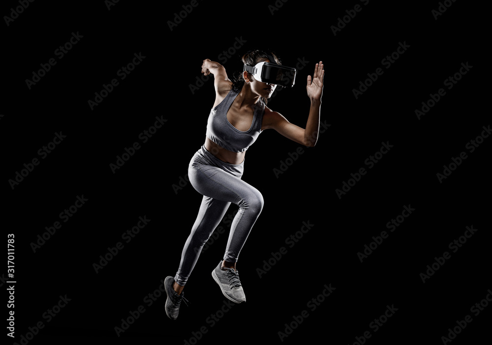 Runner woman running for Healthy. woman with VR( virtual reality ) headset glasses.Concept of Sports technology of the future