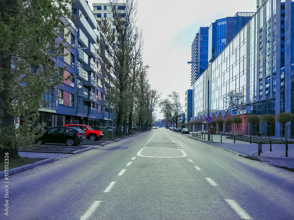 Quarantine. Empty street in a residential area of Warsaw, Poland, modern residential buildings in the city center. Coronavirus concept