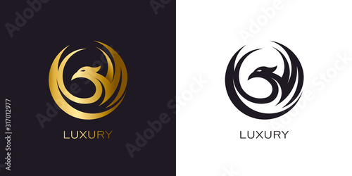 Phoenix Gold in circle logo stylized golden flying bird
