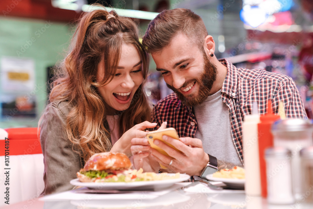 Loving couple using mobile phone. Loving couple using mobile phone.