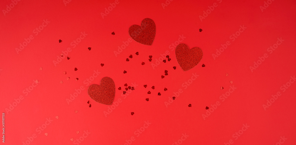 paper red shiny decorative hearts on a red background paper red shiny decorative hearts on a red background