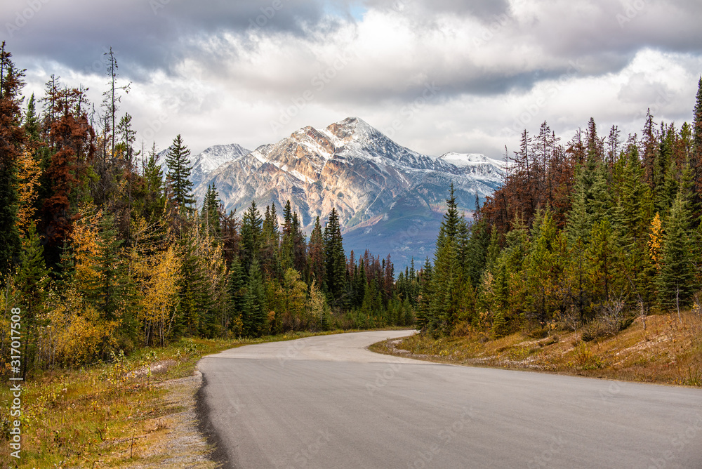 Mountain Road with scenic view of Pyramid Mountain in Jasper National Park, Canada.