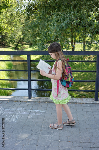 Girl reading a book outdoor
