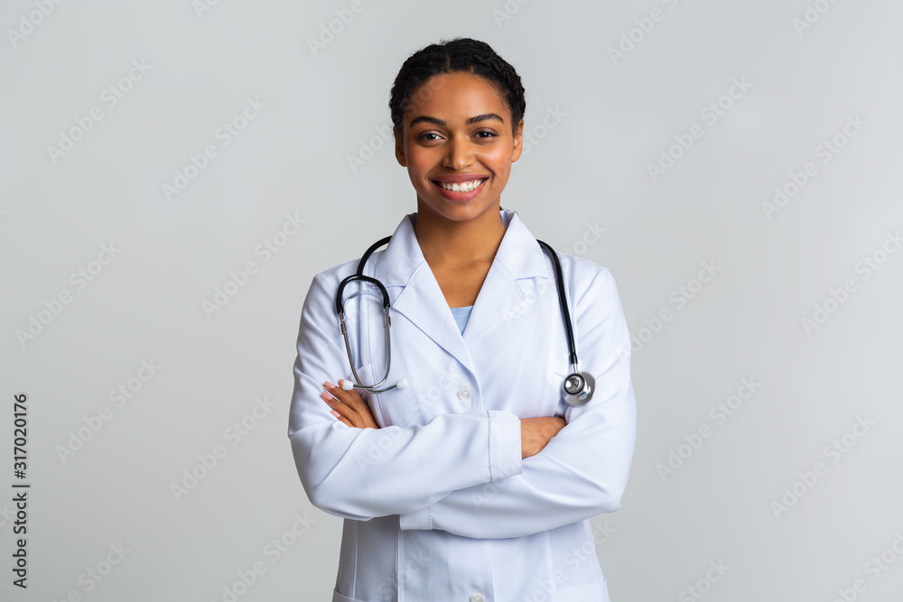 Portraif of black female doctor with stethoscope posing with crossed hands  Stock Photo | Adobe Stock