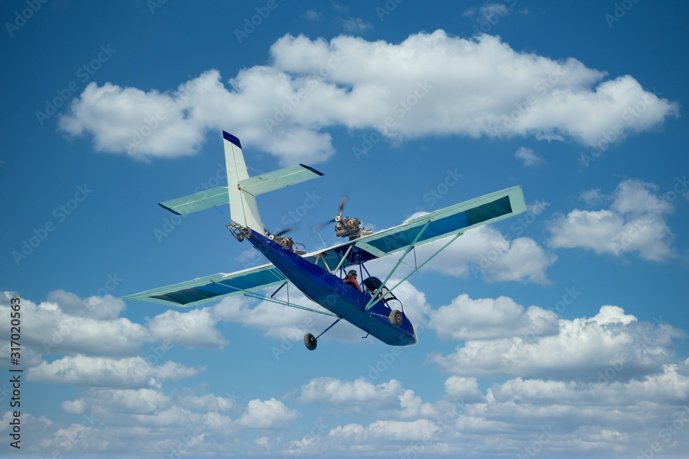 A small rear prop plane flying against the sky A small rear prop plane flying against the sky
