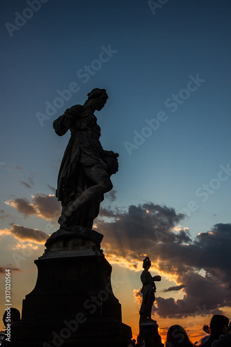 silhouette of statue with clouds
