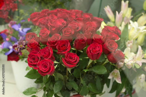 Fototapeta Naklejka Na Ścianę i Meble -  Colorful roses flowers behind the shop window. Valentine's day. Mother's Day! Holidays concept.
