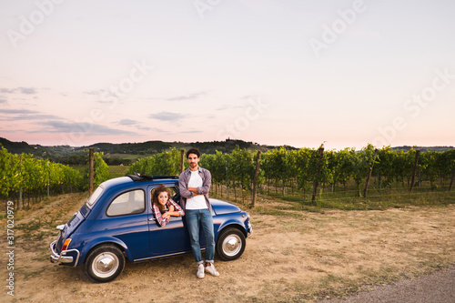 Beautiful couple trip in the country with a vintage car
