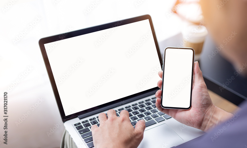 mockup image blank screen computer,cell phone with white background for advertising text,hand woman using laptop texting mobile contact business search information on desk in cafe.marketing,design mockup image blank screen computer,cell phone with white background for advertising text,hand woman using laptop texting mobile contact business search information on desk in cafe.marketing,design