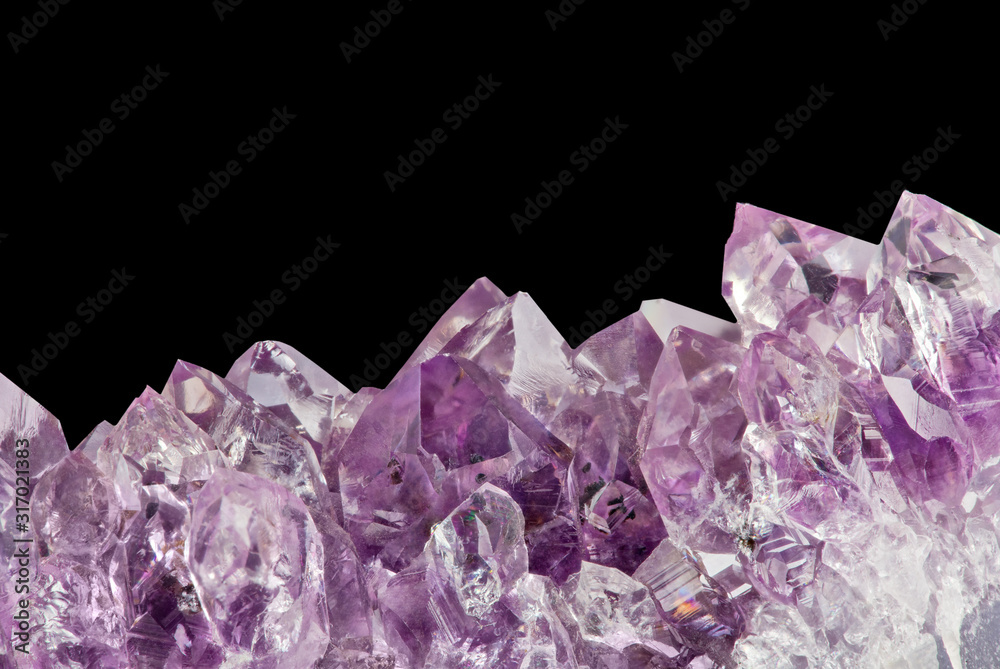 Fototapeta premium light large amethyst crystals macro on black