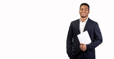 Handsome afro guy holding laptop on white background