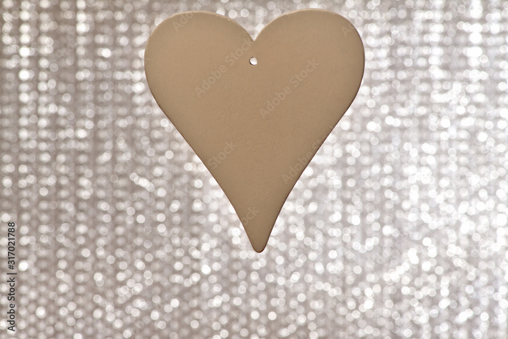 Heart. One white wooden heart with a hole for the ribbon on a shiny gray background on the center. Valentine's day, February 14. Heart. One white wooden heart with a hole for the ribbon on a shiny gray background on the center. Valentine's day, February 14.
