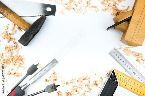 carpentry tools with wood shavings on a white background flat lay photo