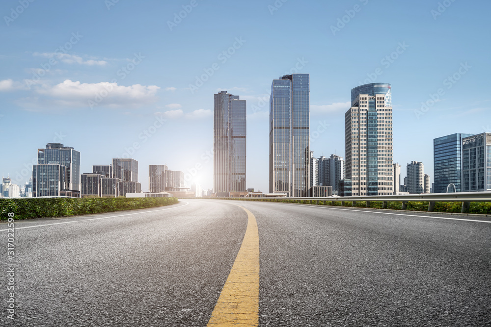 Urban road and Shanghai Bund skyline..
