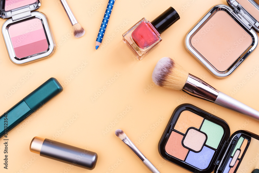 Flat view of cosmetics - lipstic, face-powder, brushes, nail polish. Flat view of cosmetics - lipstic, face-powder, brushes, nail polish.