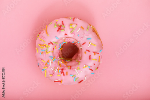 Pink donut on a pink background, minimalism concept, color game.background, copy space