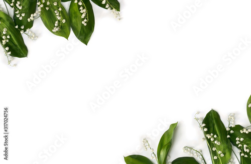 Frame of flower with leaves Lily of the valley ( Convallaria majalis, May bells, may-lily ) on a white background with space for text. Top view, flat lay photo