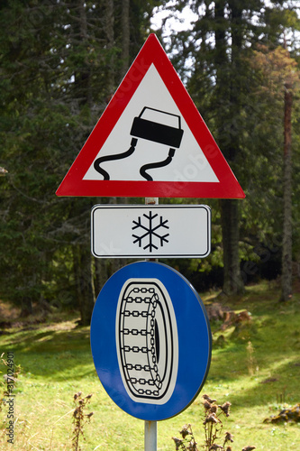 Road signs on a mountain road: warning sign 