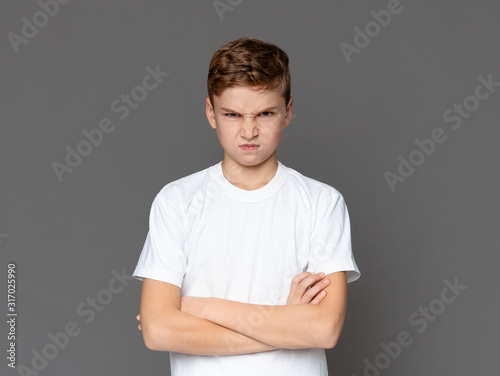 Billede på lærred Angry teenager looking at camera with offence