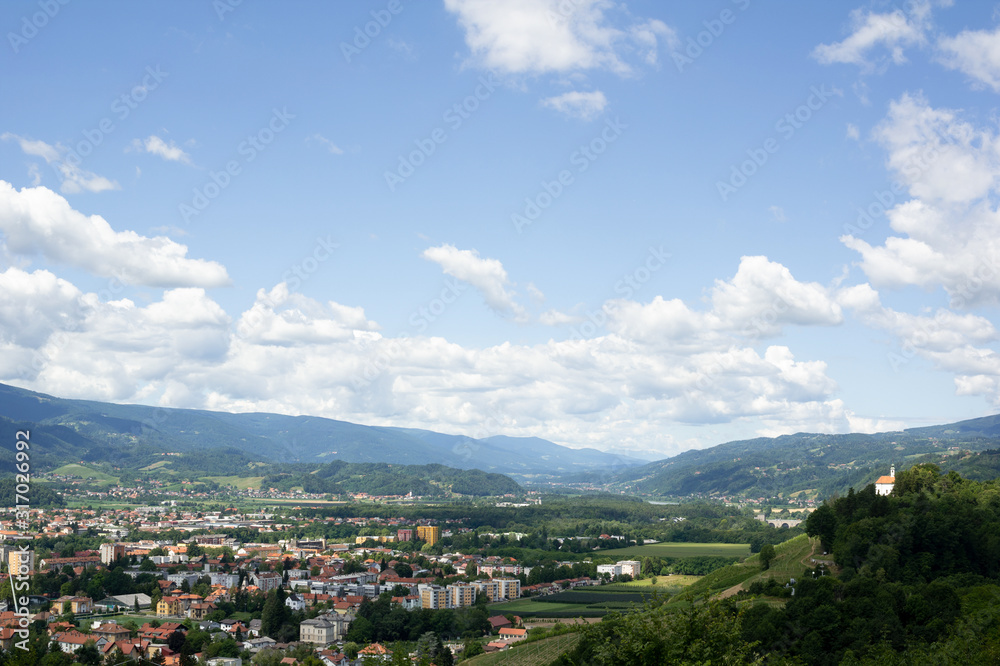 City of Maribor in Slovenia is surrounded by Kalvarija hill and nature. Blue sky with cloud as large copy space