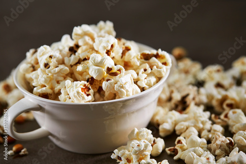 Popcorn in cup on black background 
