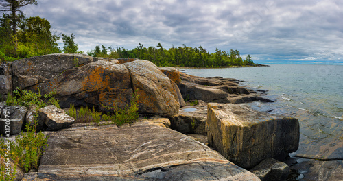 Fotografie Multibanded gneiss rocks on the shoreline of an island the Georgian Bay, in Ontario, Canada