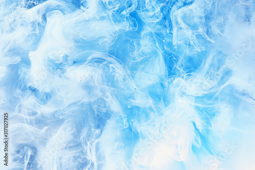 Abstract blue clear sky background with white soft clouds of smoke, lightness and weightlessness, watercolor pattern