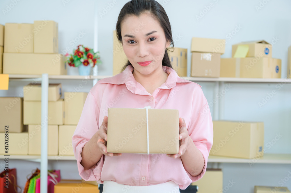 Young Asian Woman Working at home, Young business start up online seller owner, Delivery Project, Woman with Online Business or SME Concept. Young Asian Woman Working at home, Young business start up online seller owner, Delivery Project, Woman with Online Business or SME Concept.