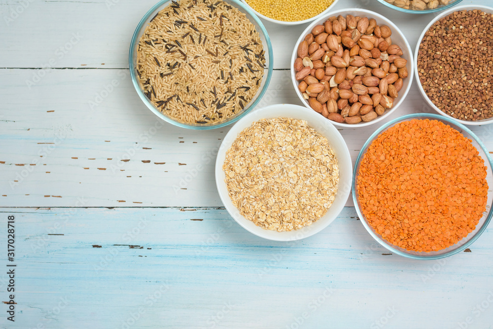 Varieties of natural organic seed in round plates of lentils, chickpeas and long brown rice, buckwheat, millet . the view from the top. space for text. healthy veggie food . diet Varieties of natural organic seed in round plates of lentils, chickpeas and long brown rice, buckwheat, millet . the view from the top. space for text. healthy veggie food . diet