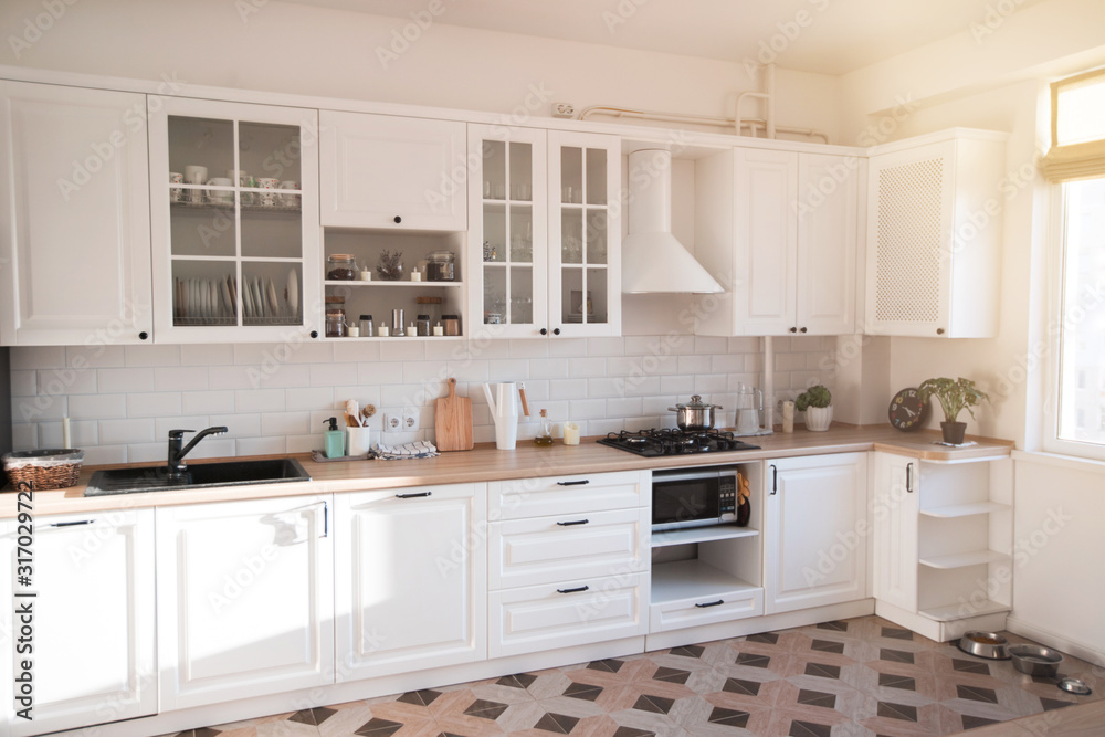 Light modern kitchen in cozy house. Home interior. Light modern kitchen in cozy house. Home interior.
