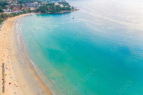 Kata beach, Paradise beach with golden sand, crystal water and palm trees, Patong area on Phuket Island, Tropical travel destination, Thailand. Aerial