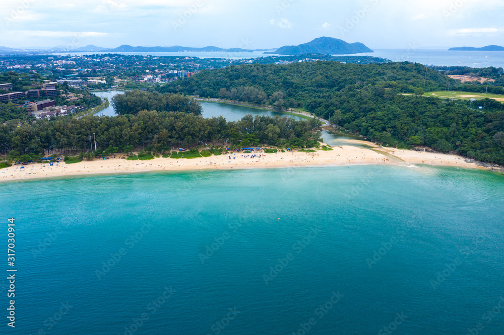 Aerial view of beautiful tropical beach and sea with palm and other tree in Phuket island for travel and vacation. Nai Han Beach