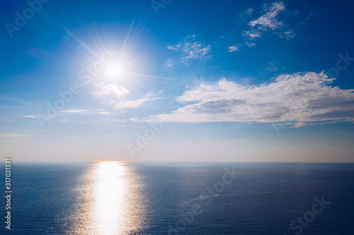 Sun over ocean. Sea landscape. Sun Over Tropical Ocean With Vibrant Colors. Coast of beach at day. Nature composition. Perfect sky and water of ocean.