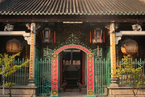 Red entrance gate to a traditional chinese buddhist temple in Saigon, Vietnam (Ho Chi Minh City)