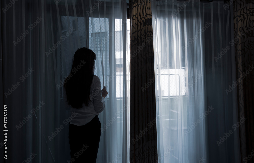 Sad young woman sitting on the bed in the bedroom, People with depression concept. Sad young woman sitting on the bed in the bedroom, People with depression concept.