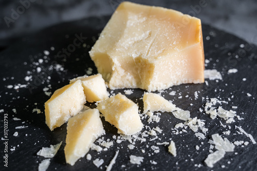 Italian Cheese on black stone background