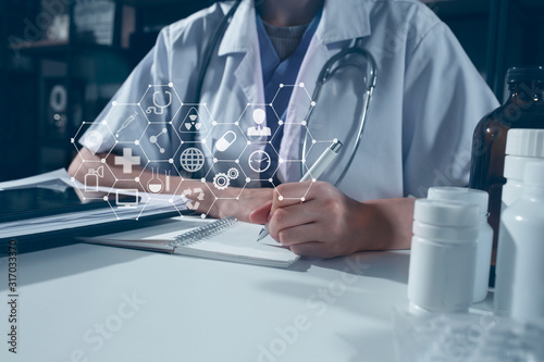 Doctor using digital laptop against dental equipment with medical network icon connection on modern virtual screen interface, medical technology networking concept.