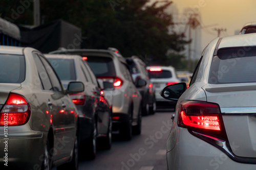 Brake light of luxury white car stop on the road. During the evening traffic in city. © thongchainak