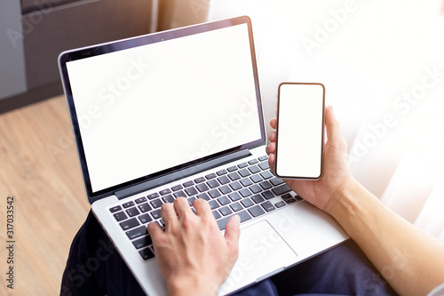 mockup image blank screen computer,cell phone with white background for advertising text,hand woman using laptop texting mobile contact business search information on desk in cafe.marketing,design