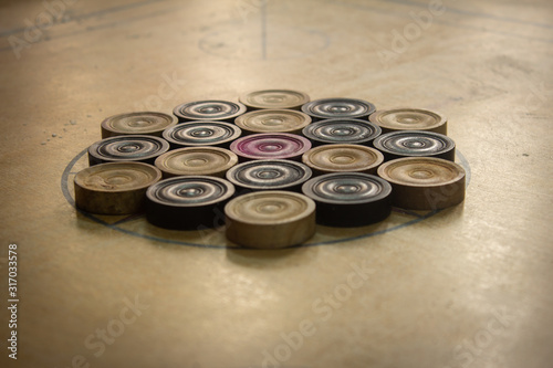 Coins arranged in order for carrom board game. Multiplayer board game with good fun time.
