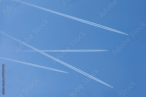 four aircrafts in the ski make a graphic sign with condensation trails with copy space for your text